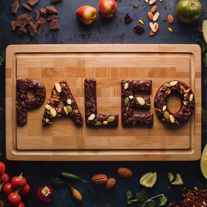 Arrangement of Paleo diet friendly foods including chocolate to spell the word "Paleo"