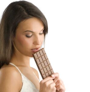 a girl about to eat chocolate, looking blissful