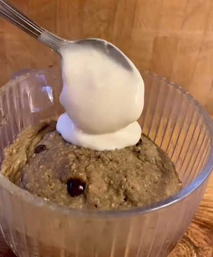 Adding vegan yogurt to the cookie dough baked oat mug cake 