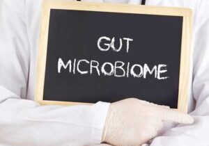 A doctor holds up a gut-mircobiome sign